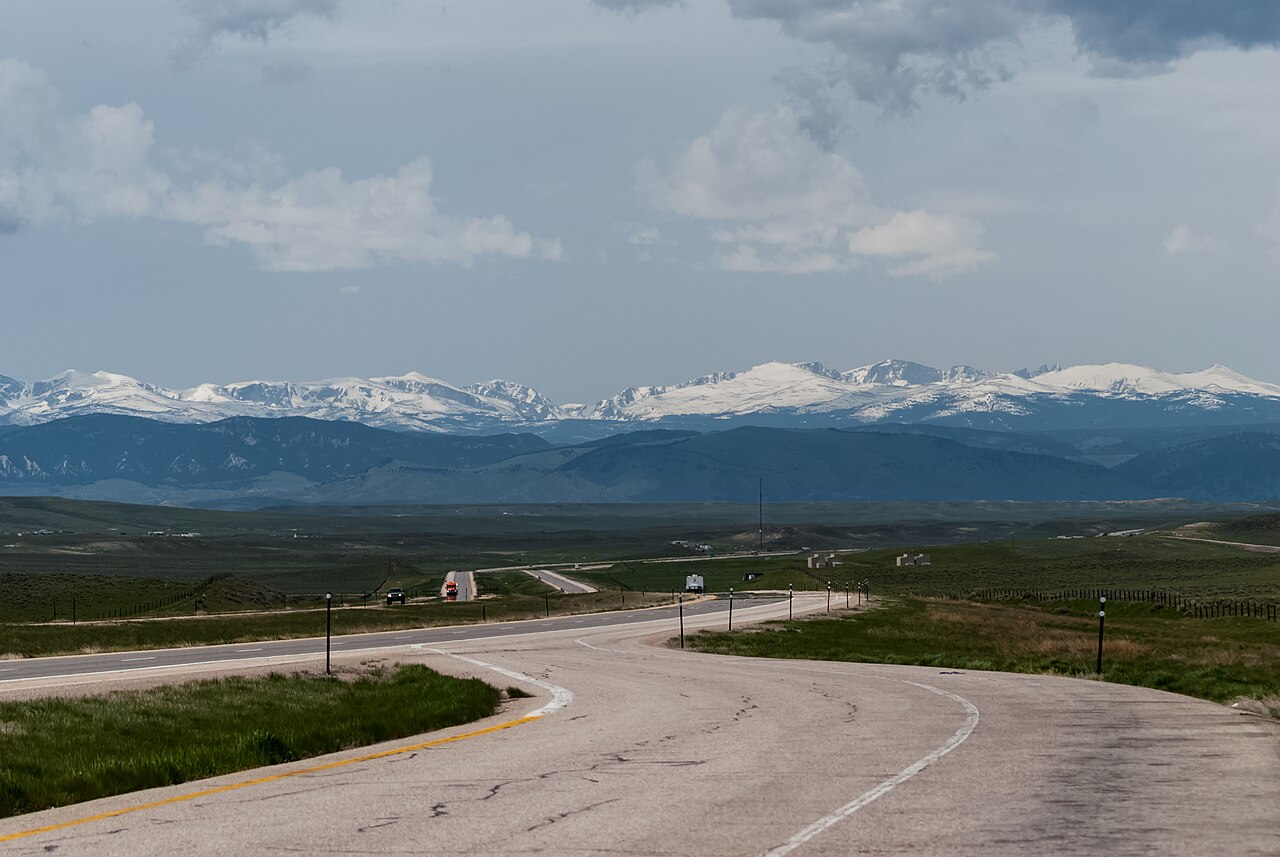 A scenic view of distant mountains across the plains from Interstate 94 in Montana, the highway that crosses the McLaughlin Hill grade.